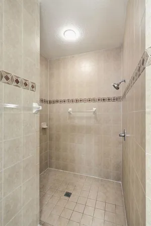 a view of a kitchen with a sink and a refrigerator