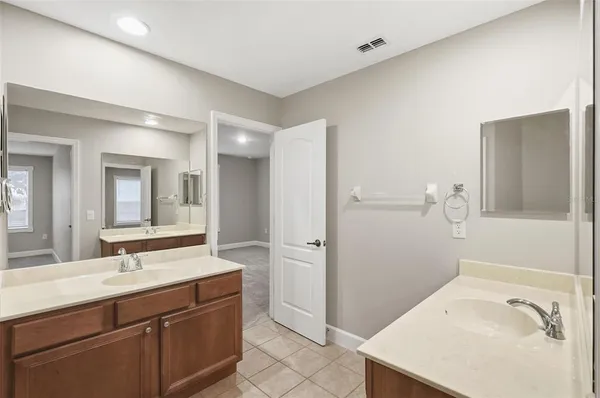 a bathroom with a sink mirror and shower