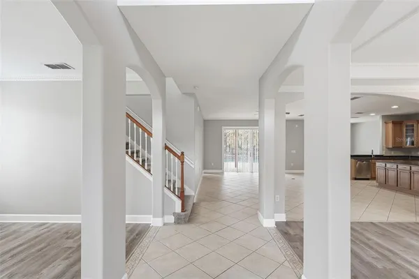 an empty room with wooden floor and fireplace