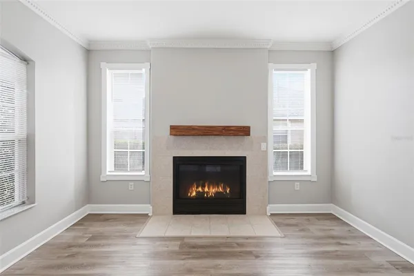 a living room with a fireplace and a window