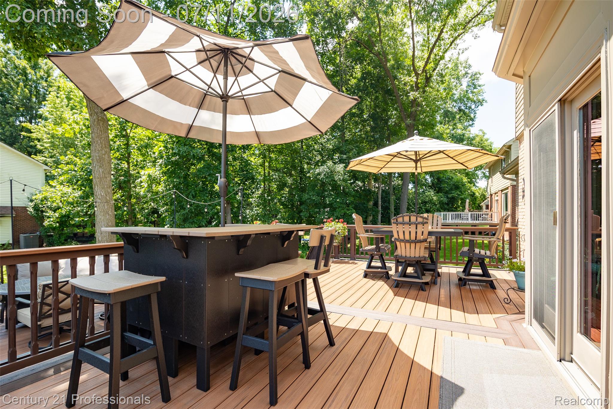 689 Woodfield Way Rochester, MI 48307 - Photo 29 of 61 Spacious outdoor deck featuring light wood-finish flooring, a built-in bar, and a sliding glass exterior door
