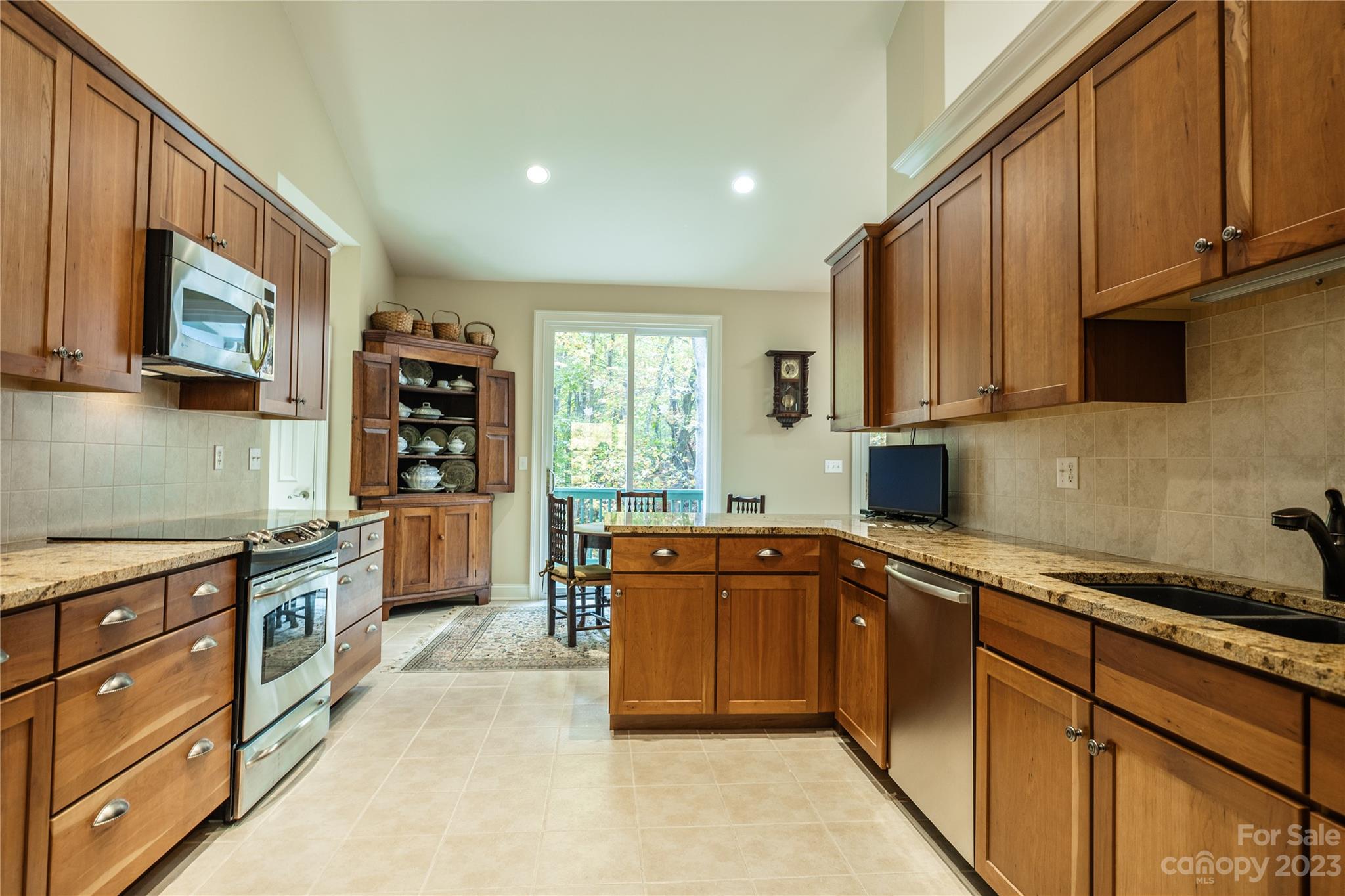 41 Silk Tree Road Hendersonville, NC 28739 - Photo 8 of 32 a kitchen with stainless steel appliances granite countertop a sink and cabinets