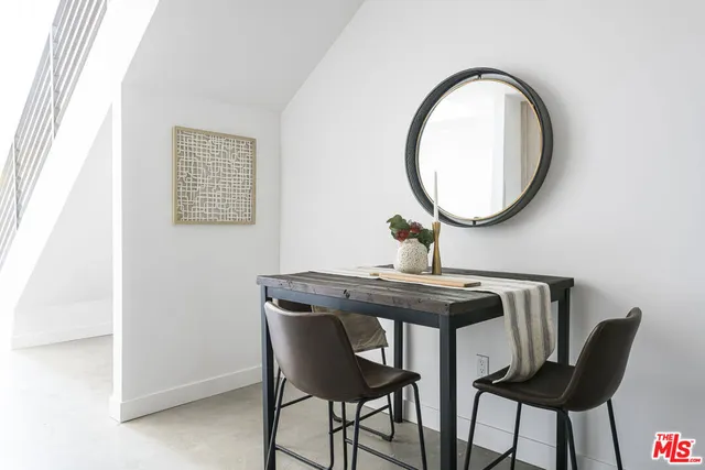 a view of a dining room with furniture and a mirror
