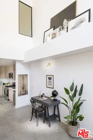 a view of a workspace with furniture and a potted plant