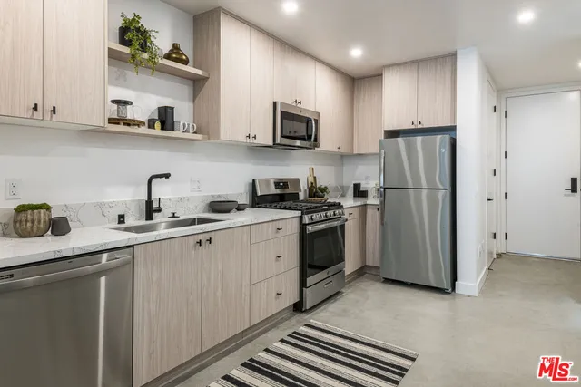 a kitchen with a sink stainless steel appliances and cabinets