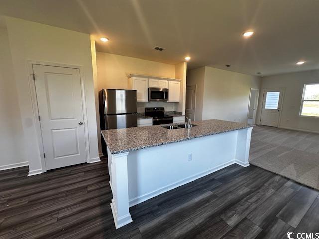 219 Linares Street Loris, SC 29569 - Photo 4 of 10 Kitchen with white cabinets, an island with sink,