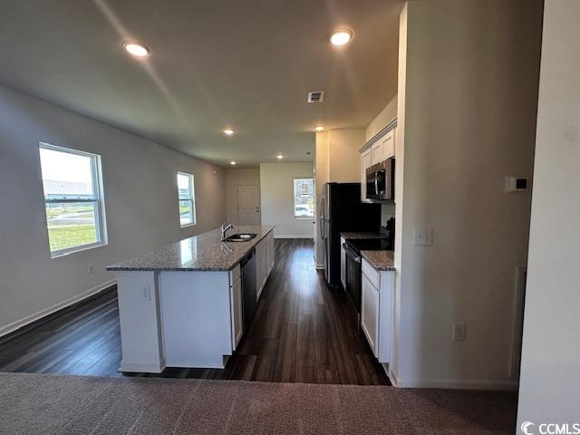 219 Linares Street Loris, SC 29569 - Photo 6 of 10 Kitchen with white cabinets, sink, a kitchen islan