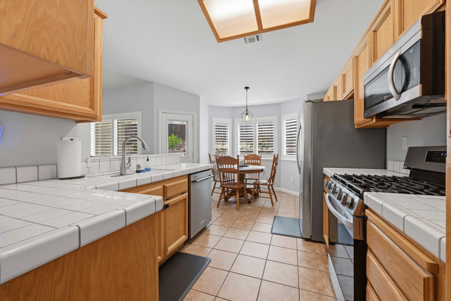 5013 Charter Road Rocklin, CA 95765 - Photo 12 of 35 a kitchen with a stove a sink and a refrigerator