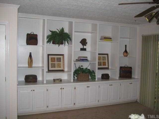 306 Broad Leaf Circle Raleigh, NC 27613 - Photo 5 of 12 a living room with furniture a potted plant and white cabinets