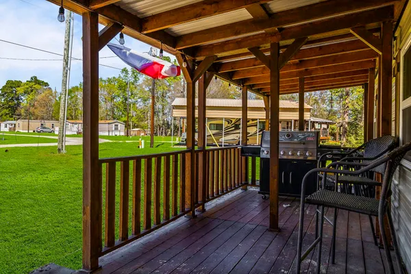 a view of a balcony with chairs and wooden floor