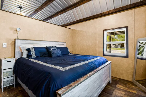 a bed sitting in a bedroom next to a window