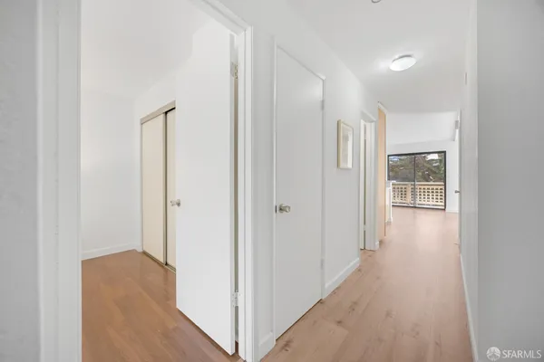 a view of a hallway with wooden floor