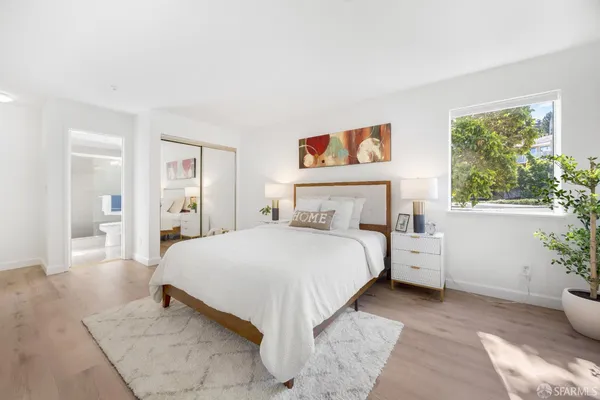 a bedroom with a bed and a large window