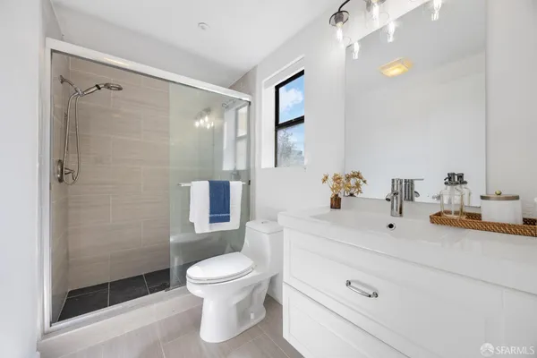 a bathroom with a sink toilet and shower