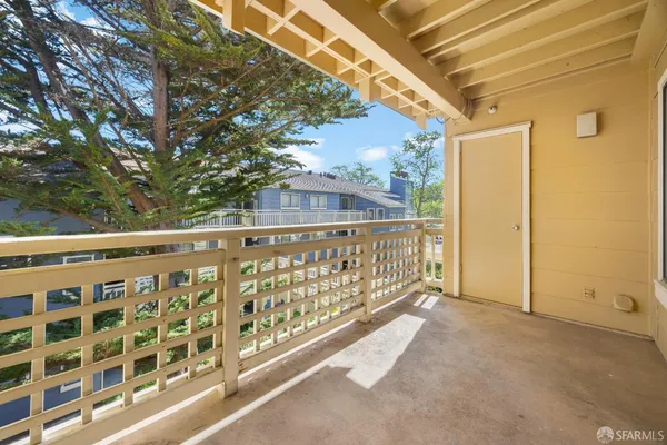 a view of balcony with wooden fence
