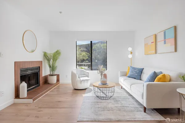 a living room with furniture and a fireplace