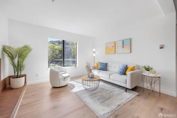 a living room with furniture and a potted plant