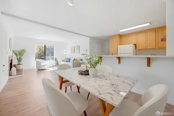 a dining room with furniture and wooden floor