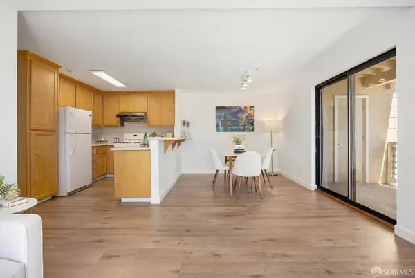 a view of kitchen with refrigerator microwave and wooden floor
