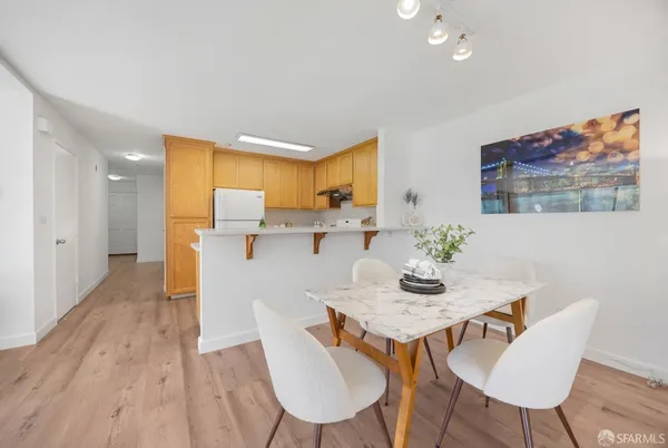 a view of a dining room with furniture and wooden floor