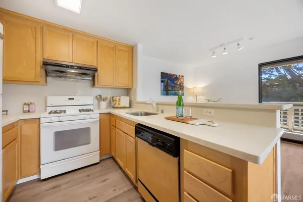 a kitchen with a sink stove and cabinets