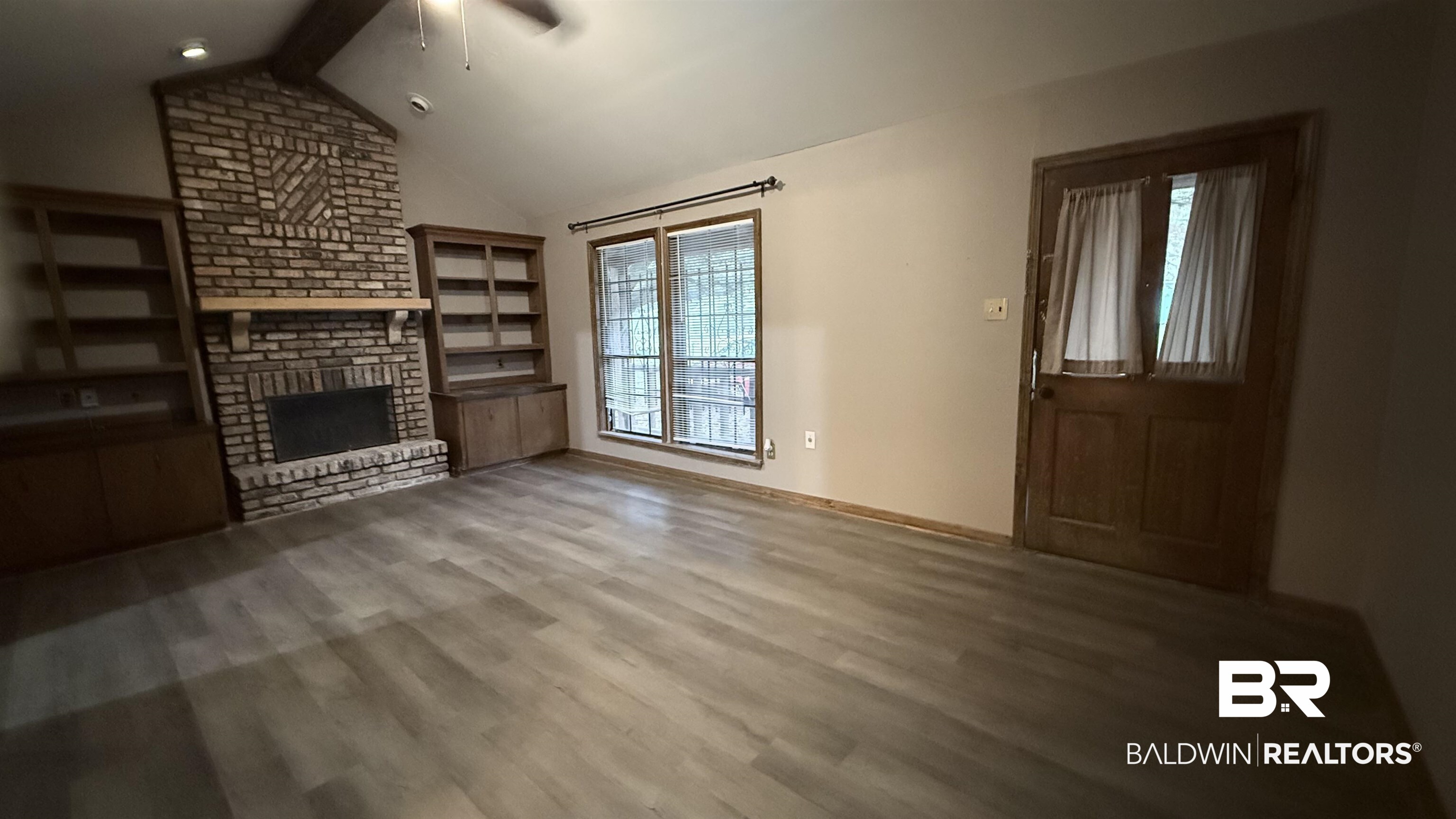 4131 Springdale Road Mobile, AL 36609 - Photo 26 of 28 Unfurnished living room with a brick fireplace, wood finished floors, and ceiling fan