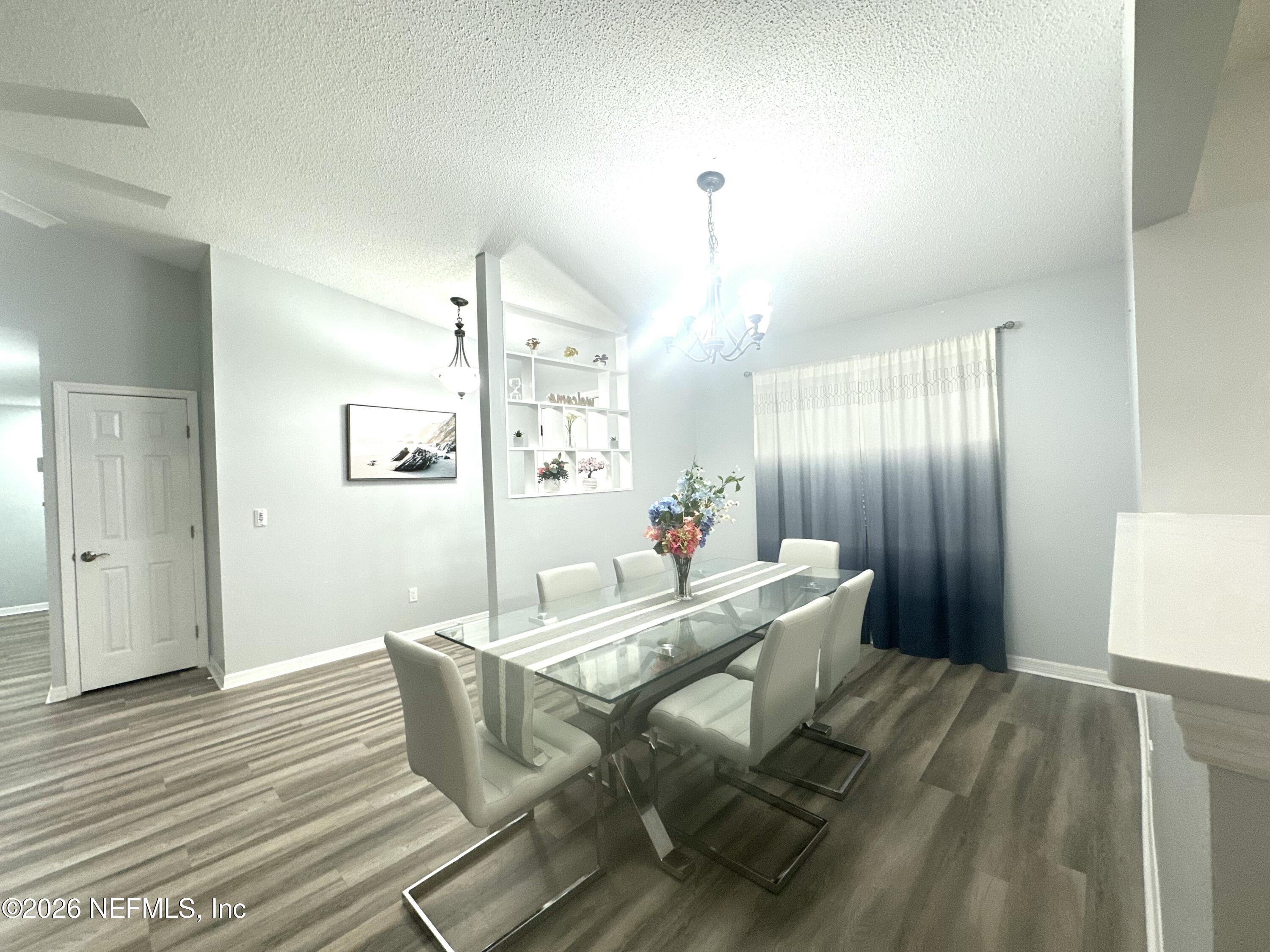 1516 Derringer Road Jacksonville, FL 32225 - Photo 11 of 55 a view of a dining room with furniture and wooden floor