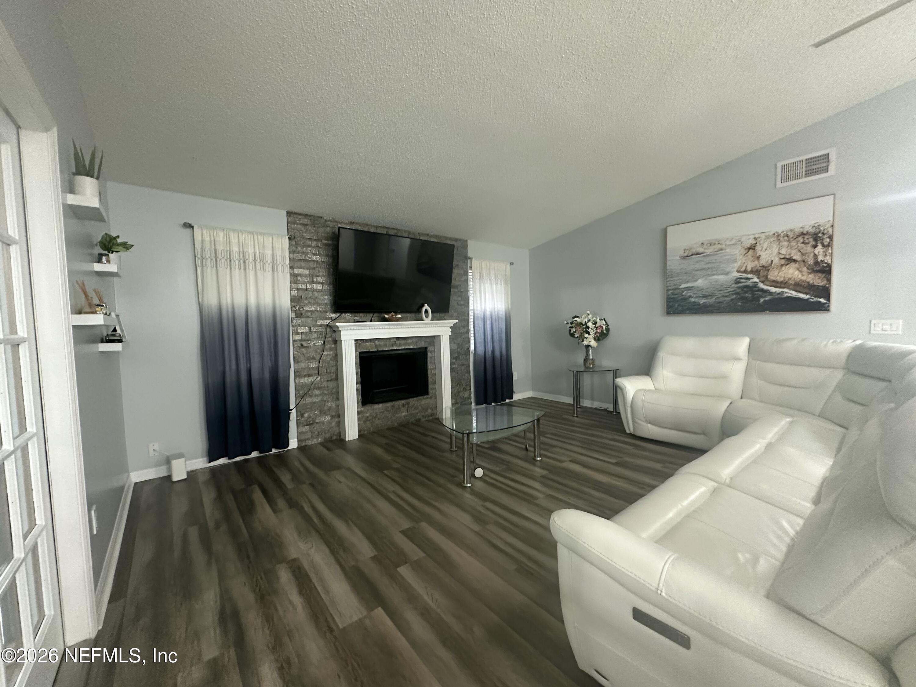 1516 Derringer Road Jacksonville, FL 32225 - Photo 14 of 55 a living room with furniture and a flat screen tv