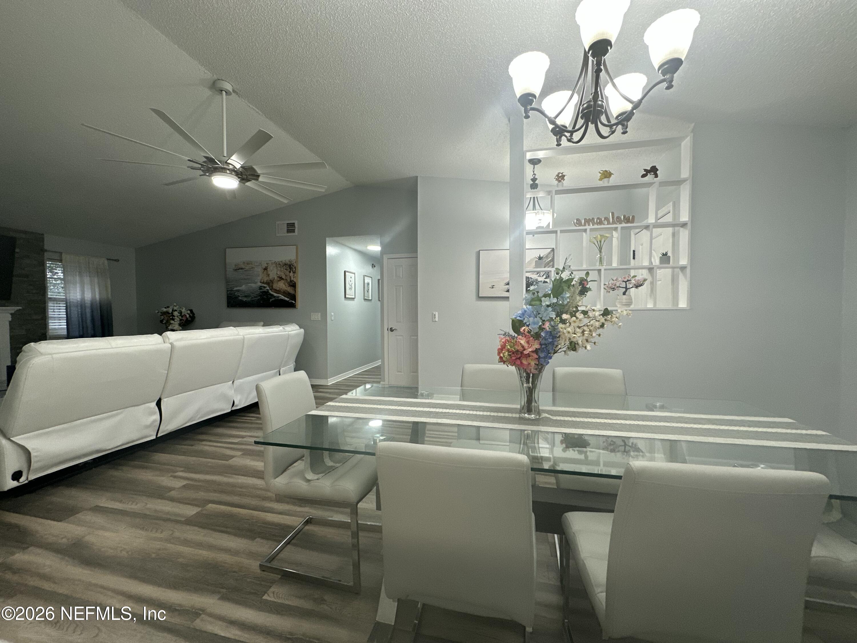 1516 Derringer Road Jacksonville, FL 32225 - Photo 19 of 55 a dining room with furniture a chandelier and window