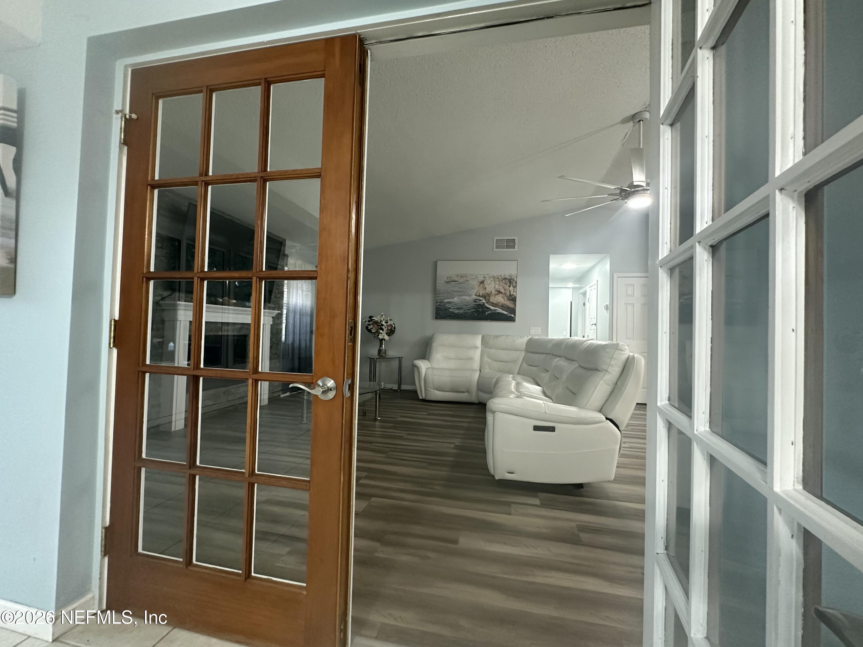 1516 Derringer Road Jacksonville, FL 32225 - Photo 32 of 55 a living room with furniture and a floor to ceiling window