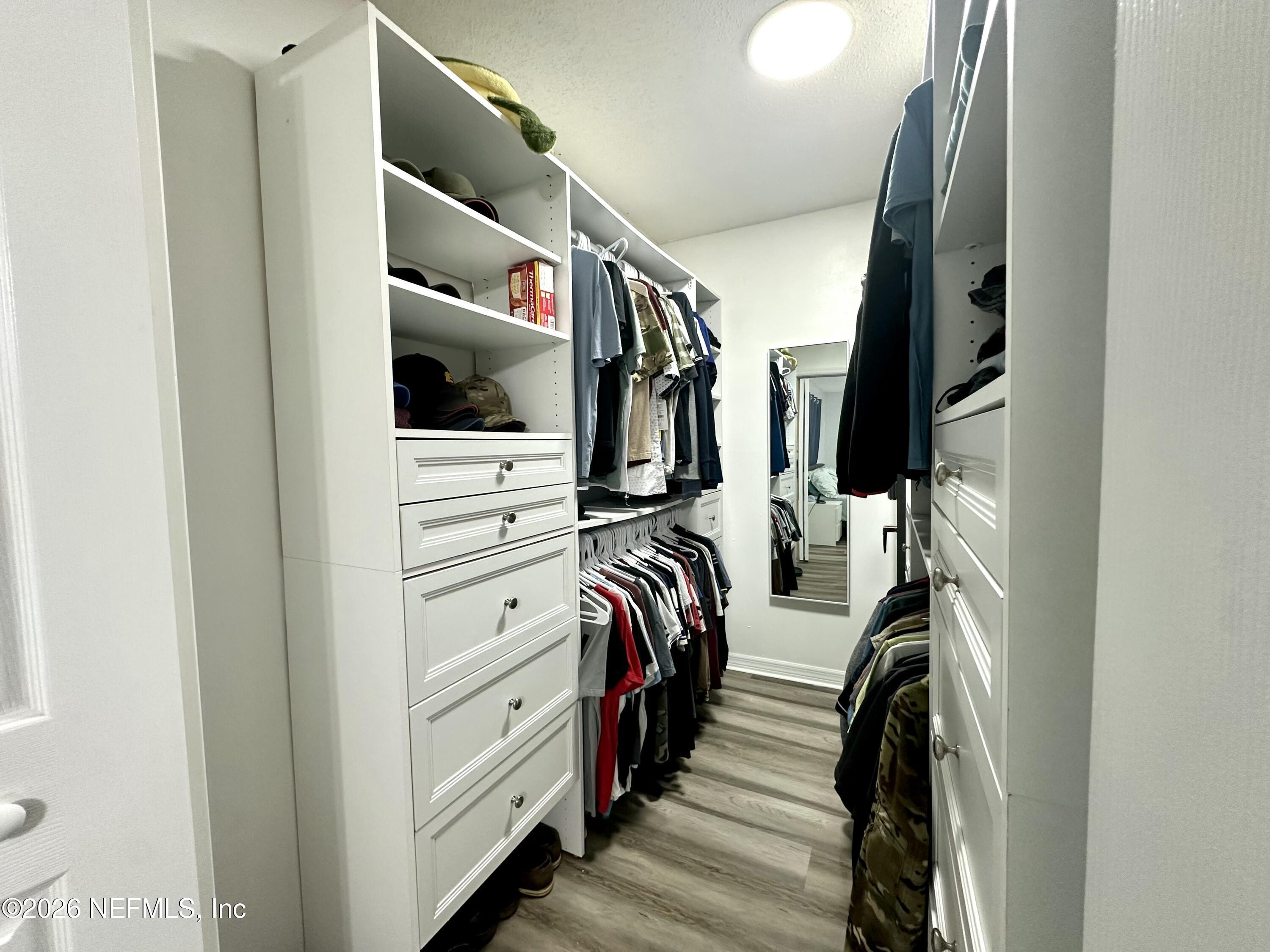 1516 Derringer Road Jacksonville, FL 32225 - Photo 45 of 55 a view of walk in closet with clothes and shoes