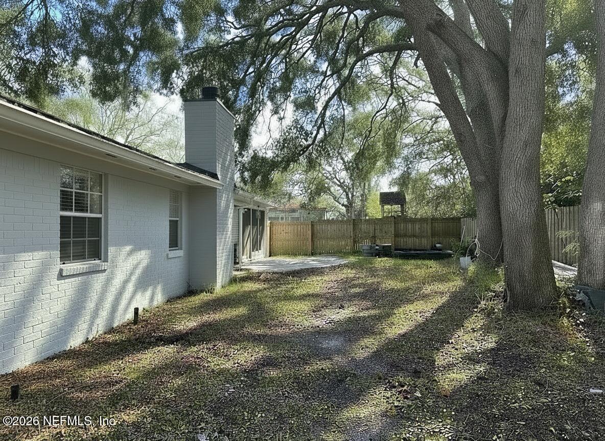 1516 Derringer Road Jacksonville, FL 32225 - Photo 53 of 55 a view of a backyard with large tree
