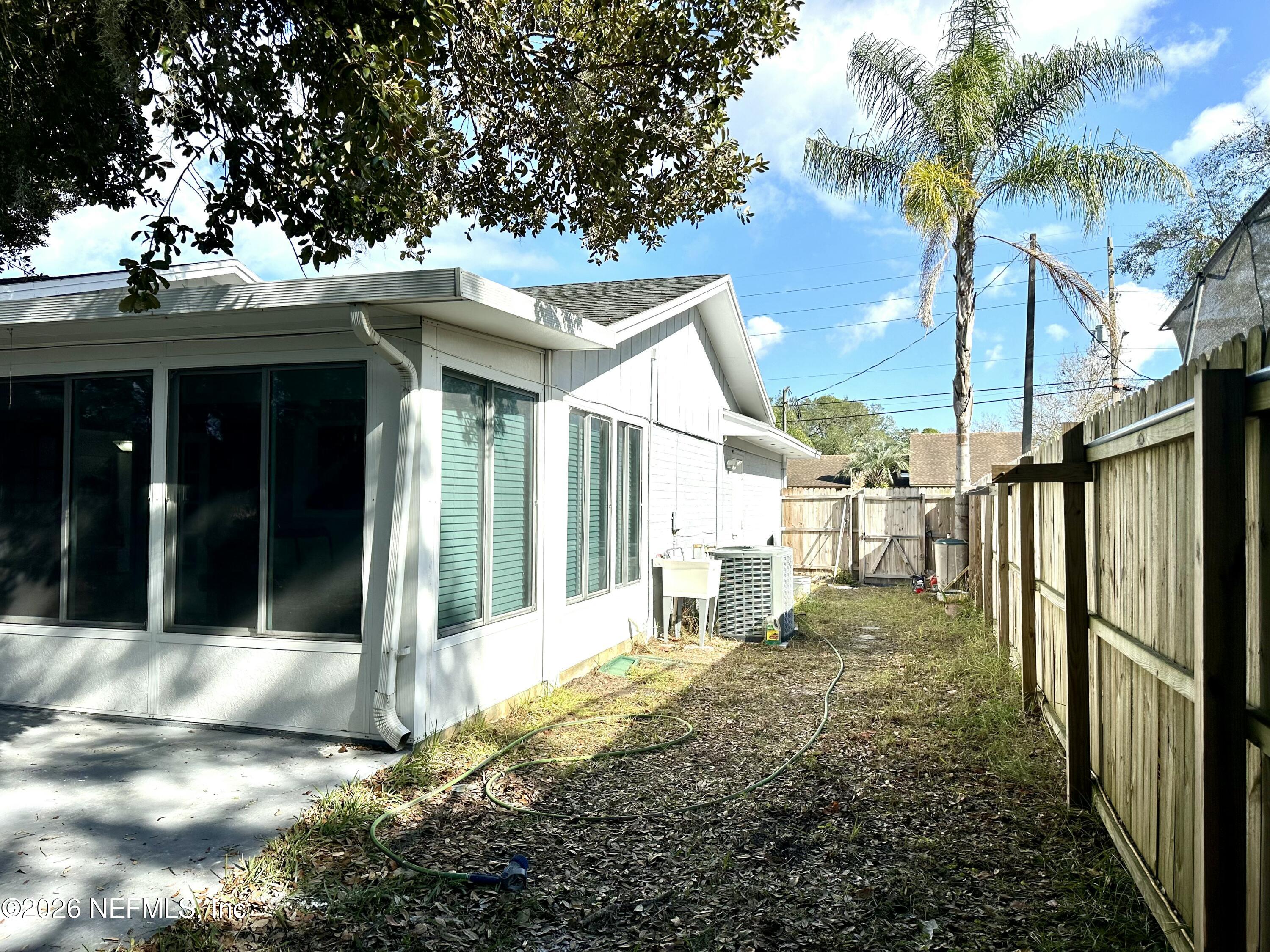 1516 Derringer Road Jacksonville, FL 32225 - Photo 55 of 55 a view of a house with a small yard and potted plants