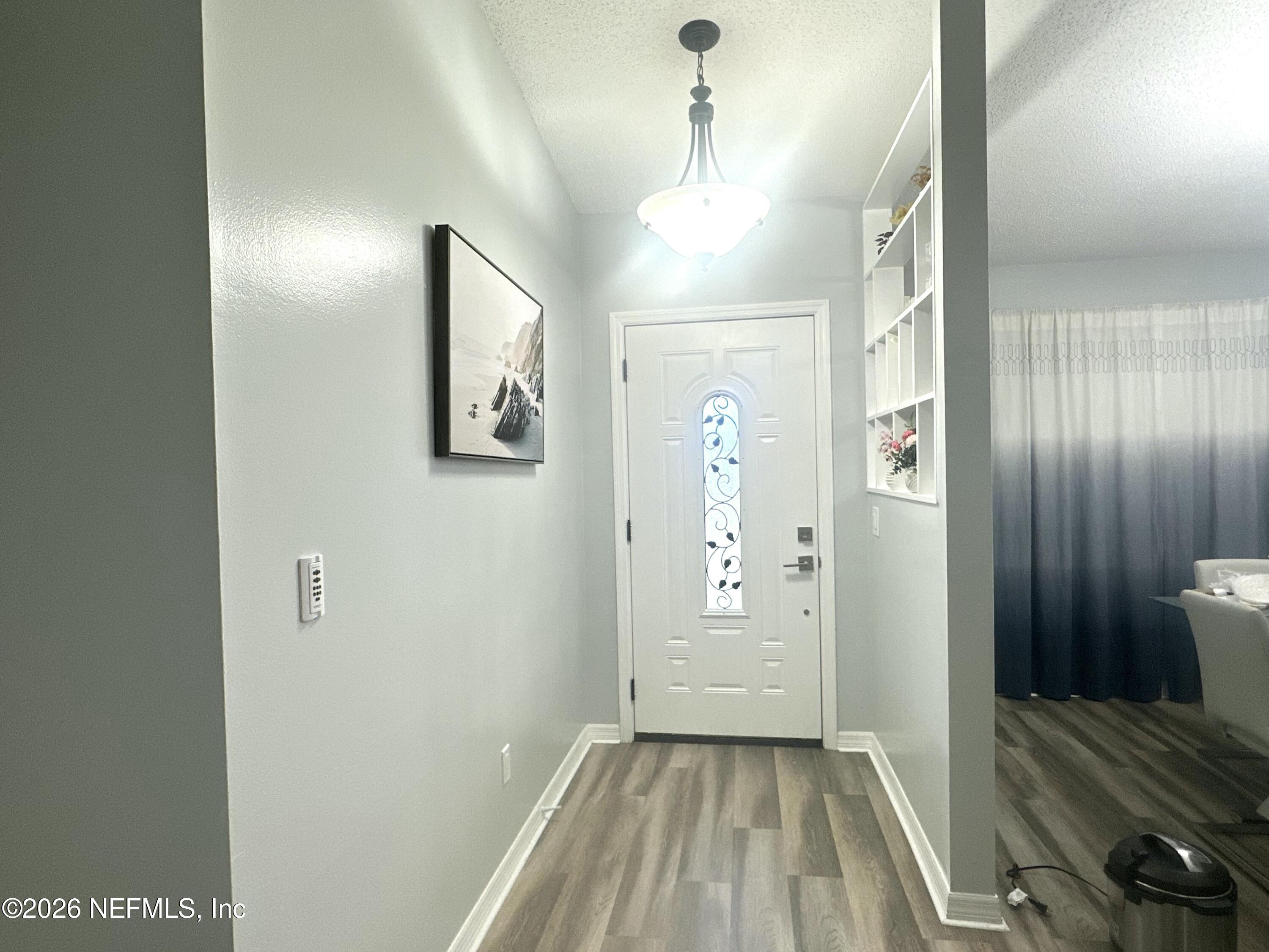 1516 Derringer Road Jacksonville, FL 32225 - Photo 8 of 55 a view of a hallway with wooden floor