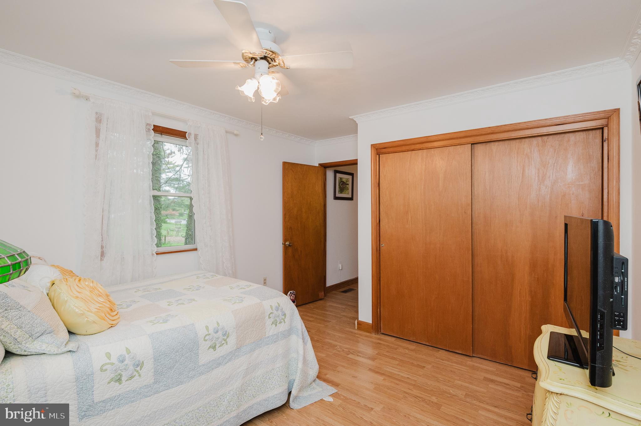 710 Magnolia Road Joppa, MD 21085 - Photo 19 of 58 a bedroom with a bed and wooden floor