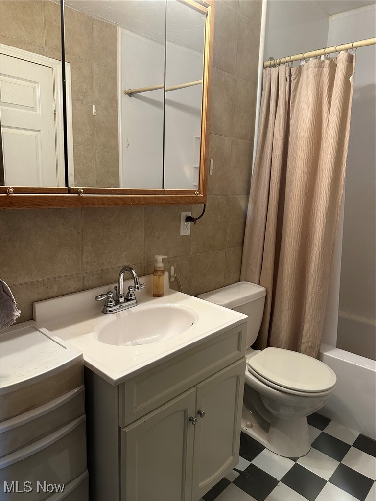 167 Andover Road Woodsfield, OH 43793 - Photo 31 of 50 Full bath featuring toilet, tile patterned floors, vanity, tile walls, and decorative backsplash