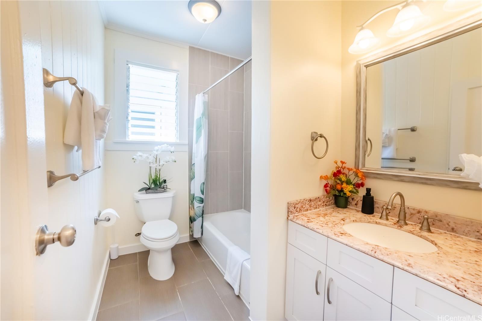 303 Wai Nani Way Honolulu, HI 96815 - Photo 12 of 24 a bathroom with a granite countertop sink toilet and shower