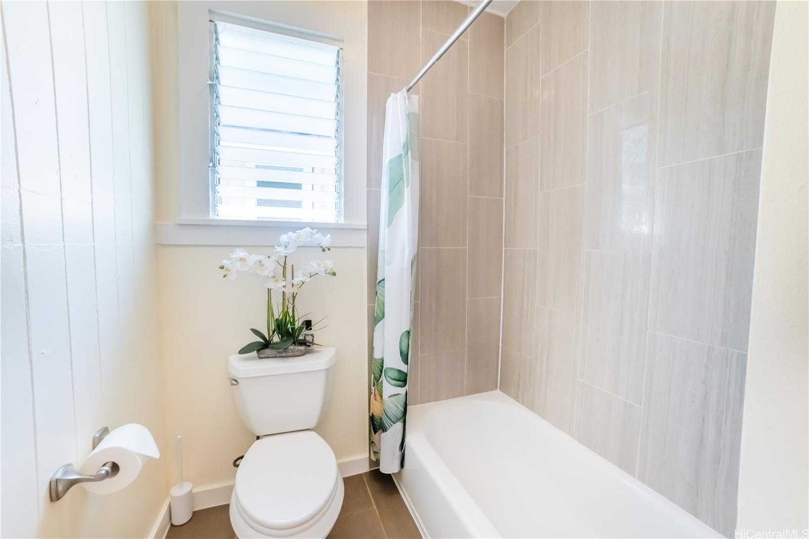 303 Wai Nani Way Honolulu, HI 96815 - Photo 13 of 24 a white toilet sitting next to a bathroom sink