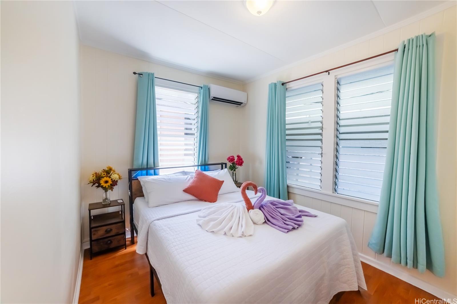 303 Wai Nani Way Honolulu, HI 96815 - Photo 2 of 24 a bedroom with a bed and a window