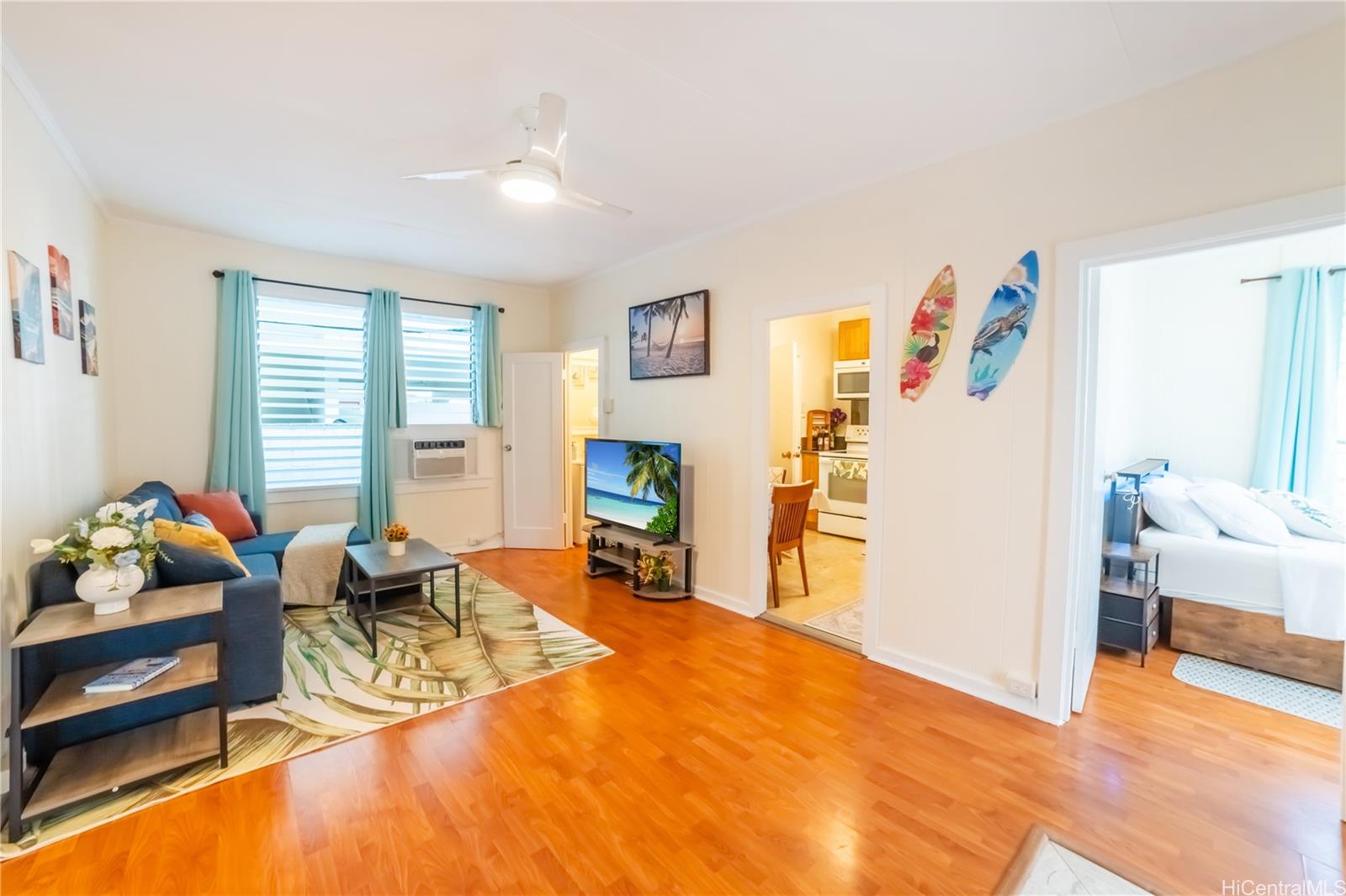 303 Wai Nani Way Honolulu, HI 96815 - Photo 23 of 24 a living room with furniture and a wooden floor