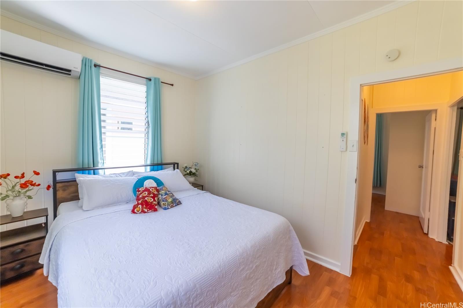 303 Wai Nani Way Honolulu, HI 96815 - Photo 6 of 24 a bedroom with a bed and wooden floor