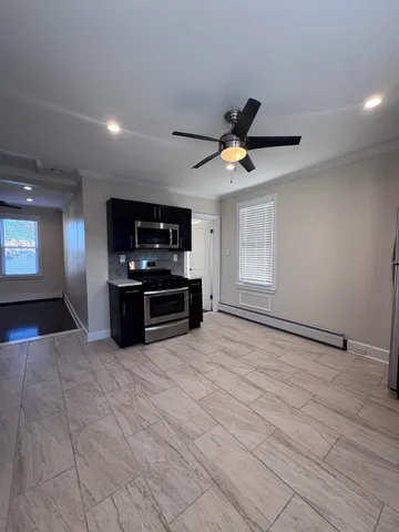 a view of kitchen with microwave stove and cabinets