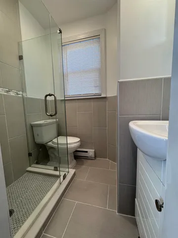 a bathroom with a sink a toilet and mirror