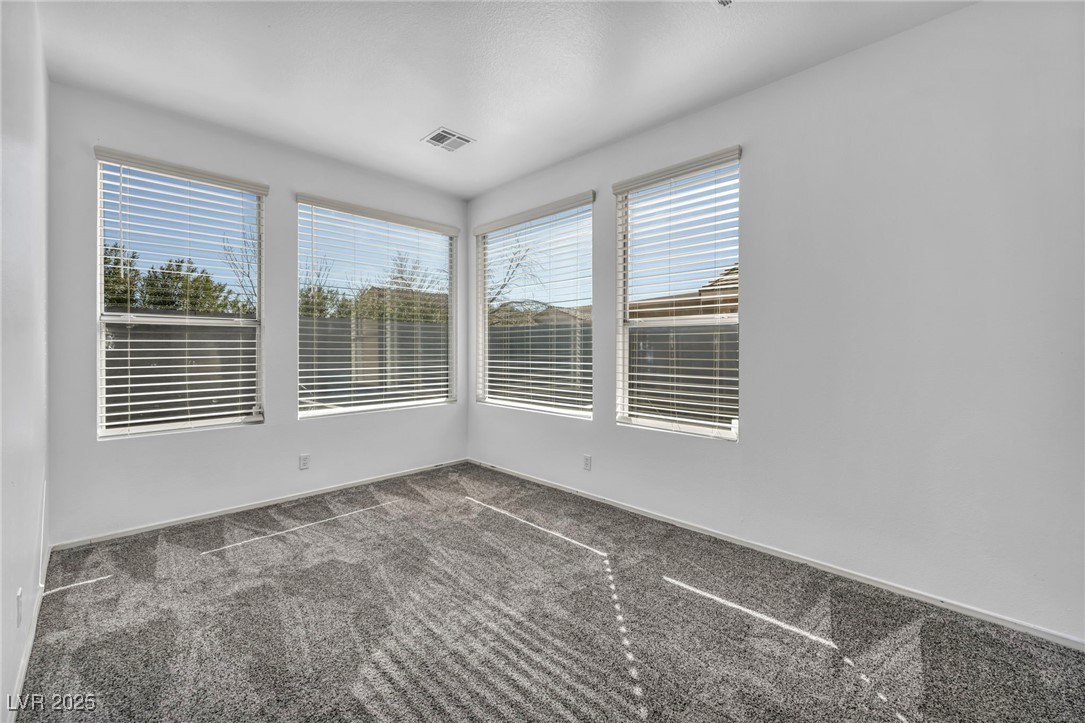 7308 Alpine Ridge Street Las Vegas, NV 89131 - Photo 19 of 47 Empty room with carpet and visible vents