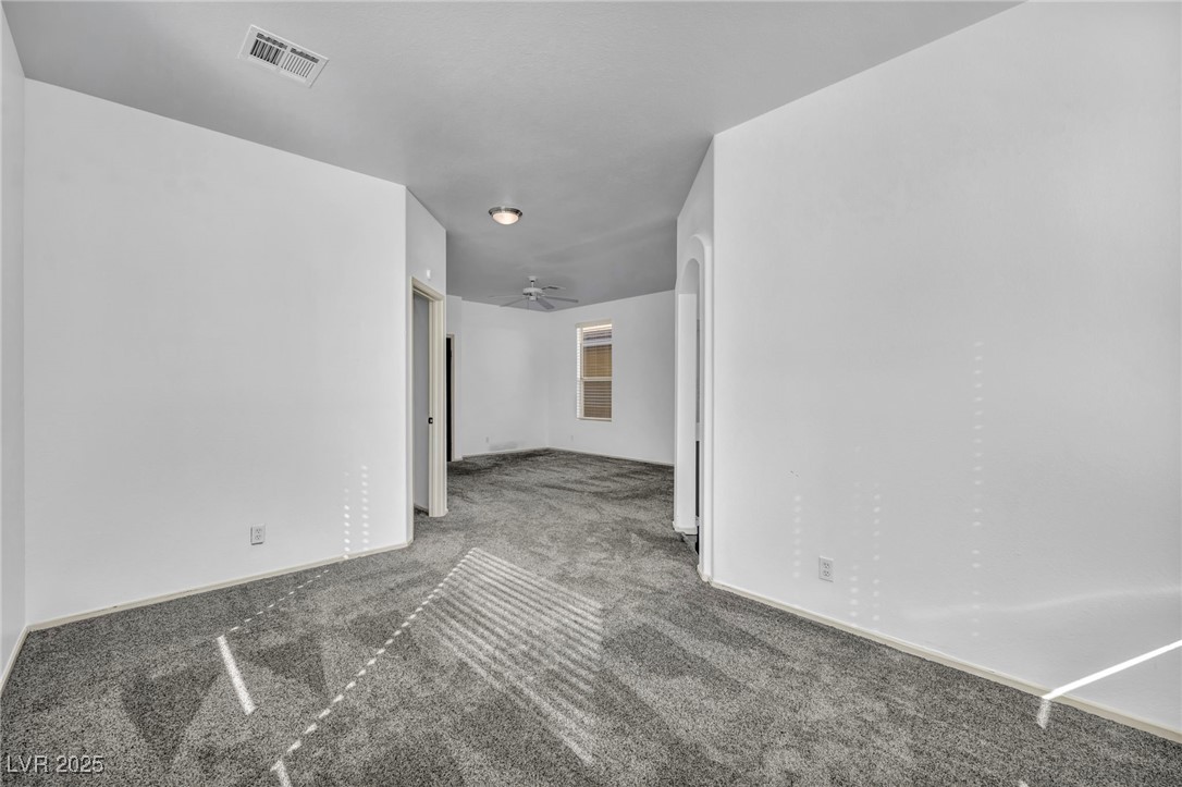 7308 Alpine Ridge Street Las Vegas, NV 89131 - Photo 20 of 47 Carpeted empty room with ceiling fan, visible vents, and baseboards