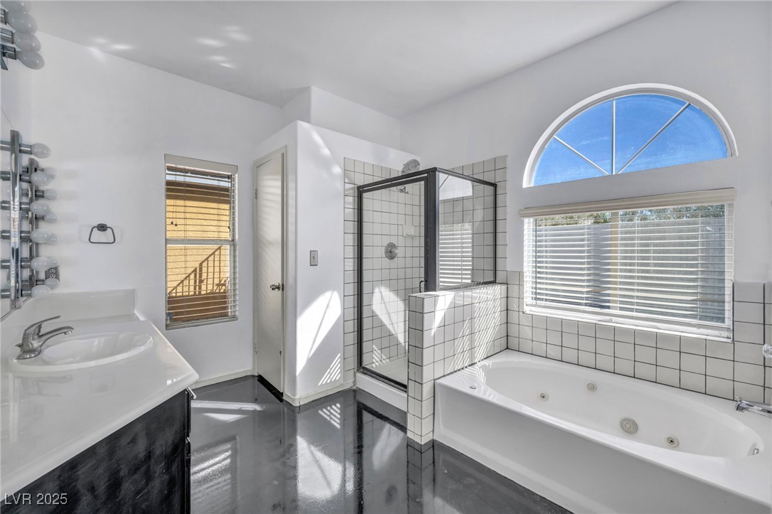 7308 Alpine Ridge Street Las Vegas, NV 89131 - Photo 22 of 47 Full bath featuring a stall shower, a sink, a whirlpool tub, and double vanity