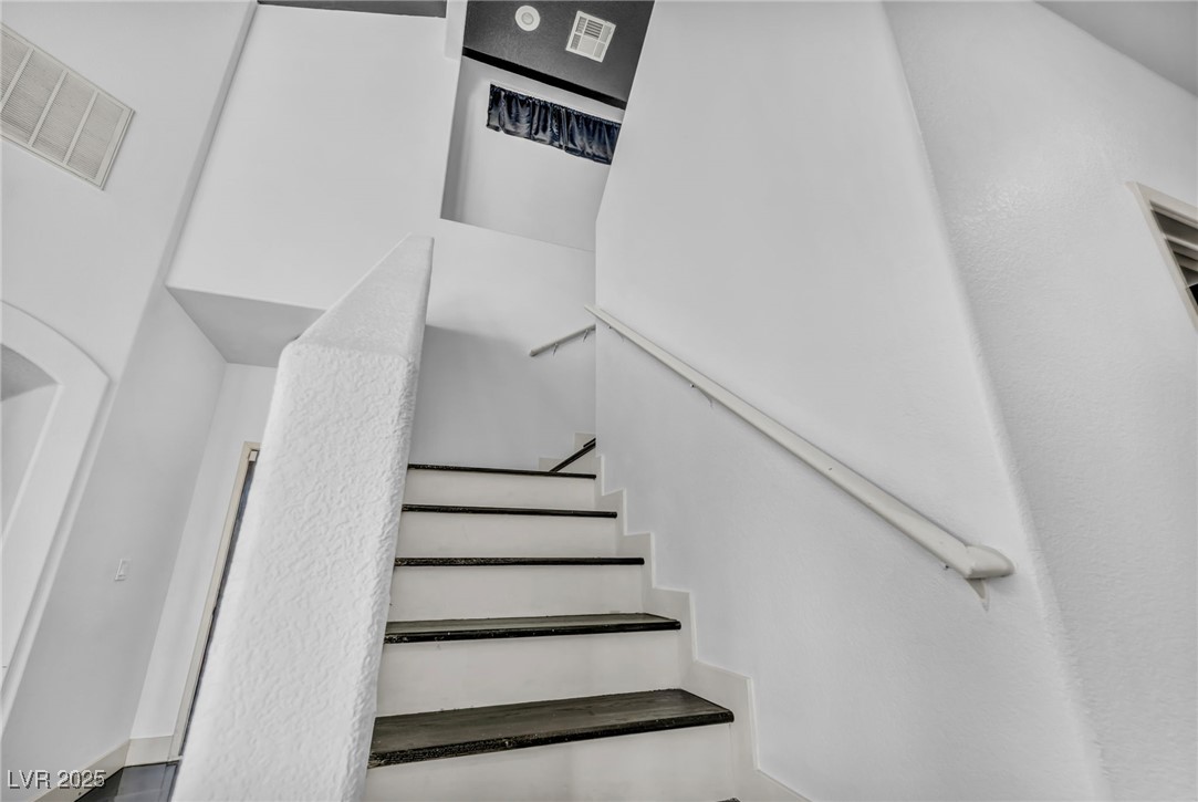 7308 Alpine Ridge Street Las Vegas, NV 89131 - Photo 27 of 47 Staircase featuring visible vents