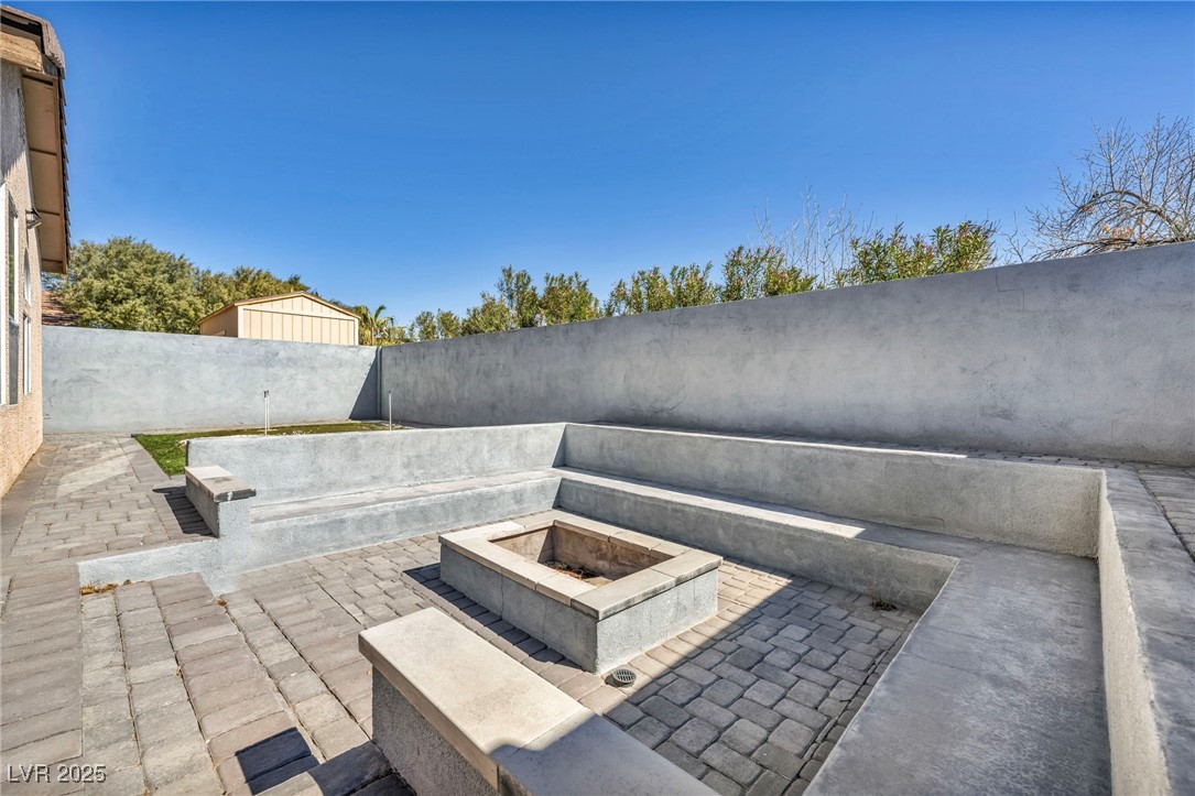 7308 Alpine Ridge Street Las Vegas, NV 89131 - Photo 38 of 47 View of patio / terrace with an outdoor fire pit and a fenced backyard