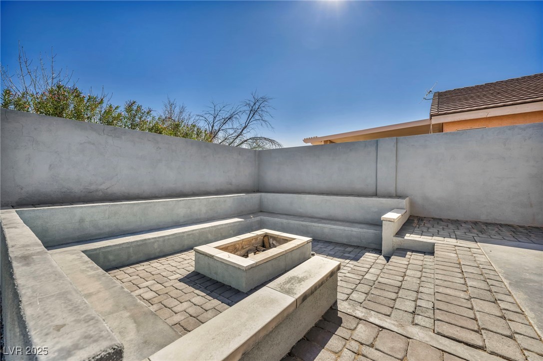 7308 Alpine Ridge Street Las Vegas, NV 89131 - Photo 42 of 47 View of patio / terrace featuring an outdoor fire pit and a fenced backyard