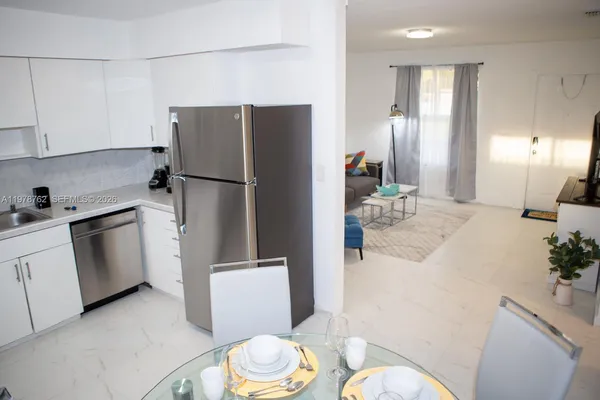 a kitchen with a refrigerator and a sink